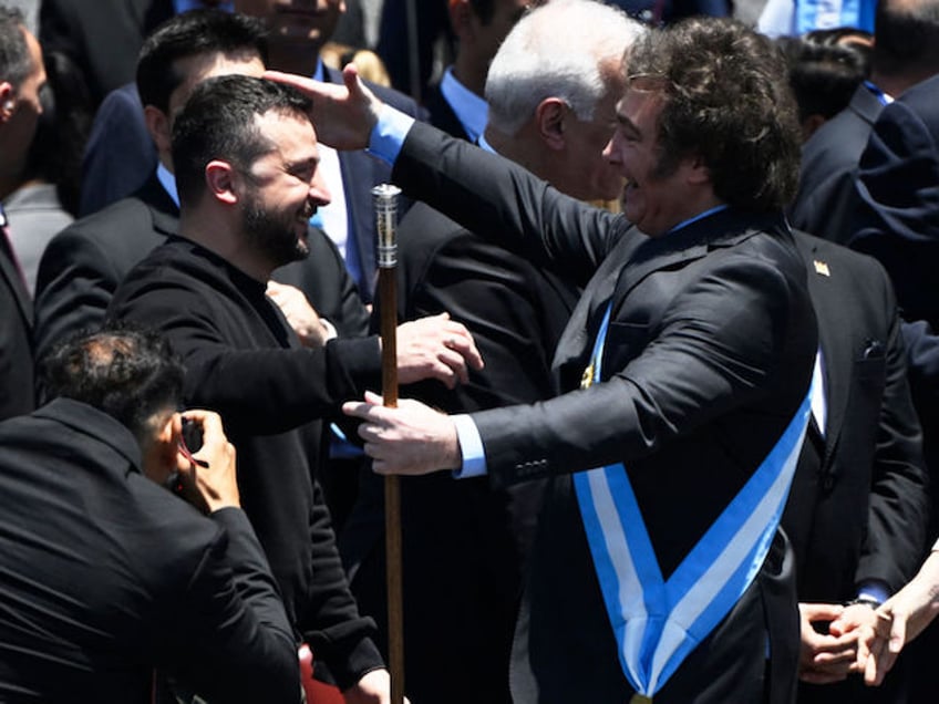 Argentina's new president Javier Milei (R) is greeted by Ukraine's President Volodymyr Zelensky after delivering his inaugural speech before the crowd during an inauguration ceremony at the Congress in Buenos Aires on December 10, 2023. Libertarian economist Javier Milei was sworn in Sunday as Argentina's president, after a resounding election victory fuelled by fury over the country's economic crisis. (Photo by Luis ROBAYO / AFP)