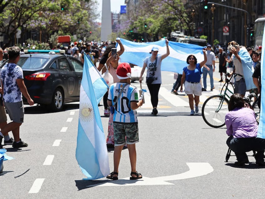 Supporters of Argentina's new president Javier Milei hold national flags during his inauguration ceremony in Buenos Aires on December 10, 2023. Libertarian economist Javier Milei was sworn in Sunday as Argentina's president, after a resounding election victory fueled by fury over the country's economic crisis. "I swear to God and country... to carry out with loyalty and patriotism the position of President of the Argentine Nation," he said as he took the oath of office, before outgoing President Alberto Fernandez placed the presidental sash over his shoulders. (Photo by ALEJANDRO PAGNI / AFP)