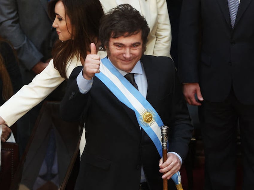 Argentina's new president Javier Milei gives the thumb up next to his vice-president Victoria Villarruel after receiving the presidential sash and baton from outgoing president Alberto Fernandez (out of frame) during his inauguration ceremony at the Congress in Buenos Aires on December 10, 2023. Libertarian economist Javier Milei was sworn in Sunday as Argentina's president, after a resounding election victory fueled by fury over the country's economic crisis. "I swear to God and country... to carry out with loyalty and patriotism the position of President of the Argentine Nation," he said as he took the oath of office, before outgoing President Alberto Fernandez placed the presidental sash over his shoulders. (Photo by ALEJANDRO PAGNI / AFP)