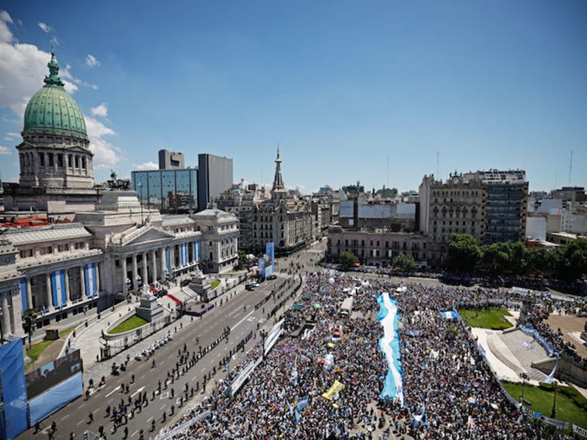 Supporters of Argentina's President-elect Javier Milei gather outside the Congress during the inauguration ceremony of Argentina's President-elect Javier Milei, in Buenos Aires on December 10, 2023. Libertarian economist Javier Milei was sworn in Sunday as Argentina's president, after a resounding election victory fueled by fury over the country's economic crisis. "I swear to God and country... to carry out with loyalty and patriotism the position of President of the Argentine Nation," he said as he took the oath of office, before outgoing President Alberto Fernandez placed the presidental sash over his shoulders. (Photo by Emiliano LASALVIA / AFP)