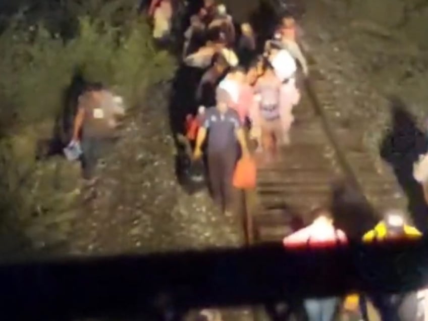 photos migrants swarm mexican railroad force train to stop