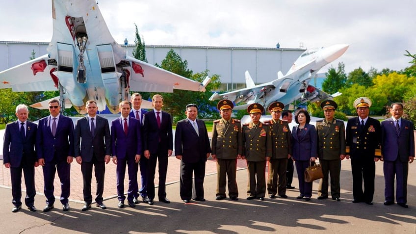 photos show kim jong un visiting sanctioned fighter jet plant in russia sitting in planes cockpit