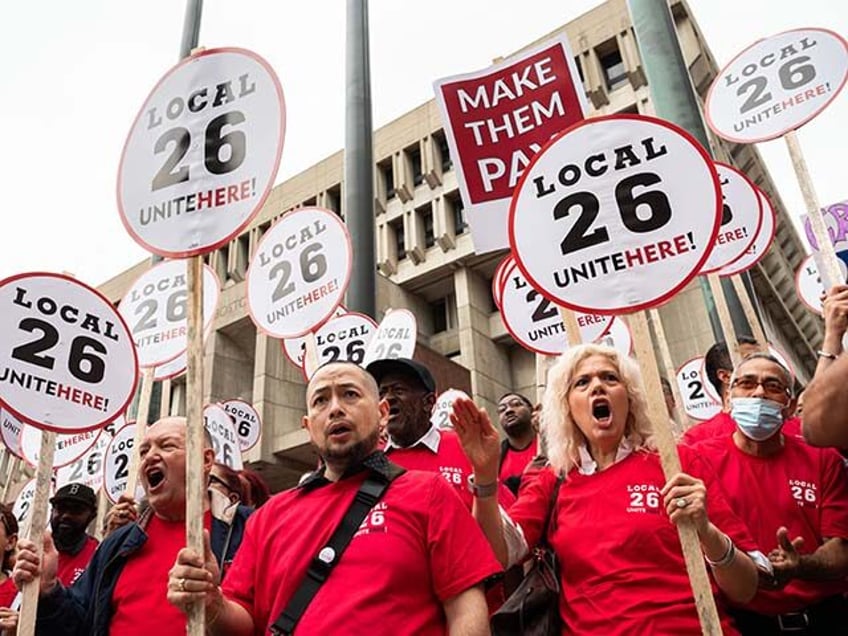 People rally at a press conference after a strike authorization vote by UNITE HERE Local 2