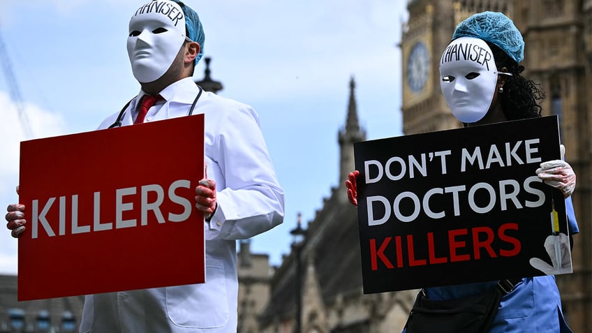 Disability campaigners from "Distant Voices and Not Dead" hold a demonstration outside Westminster Hall in central London, on April 29, 2024, protesting against proposals to legalise assisted suicide in the UK.