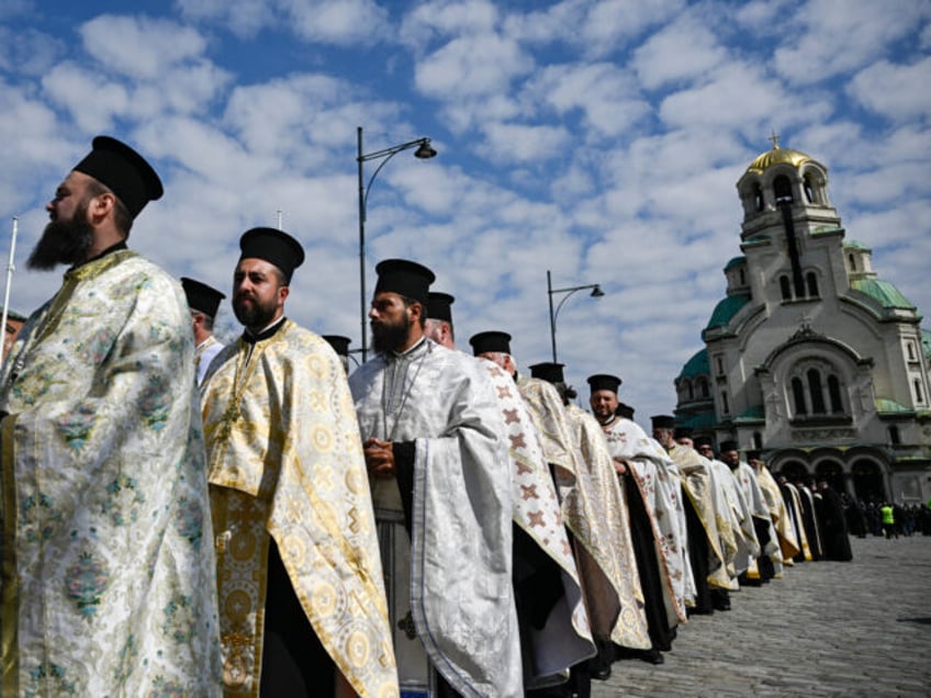 Priests take part of the funeral procession with the coffin of the late Patriarch Neophyte