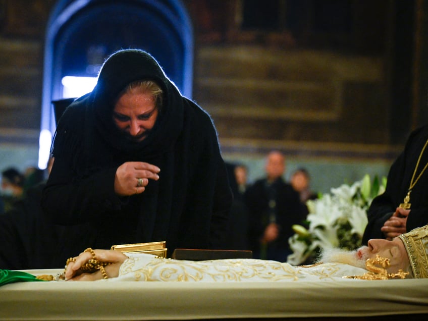 TOPSHOT - A woman pays her respects to late Patriarch Neophyte of Bulgaria's Orthodox Church during a funeral service at the golden-domed "Alexander Nevski" cathedral in Sofia on March 15, 2024. Bulgaria bid its last farewell to its Christian Orthodox religious leader Patriarch Neophyte, who died on March 13 at the age of 78. (Photo by Nikolay DOYCHINOV / AFP) (Photo by NIKOLAY DOYCHINOV/AFP via Getty Images)