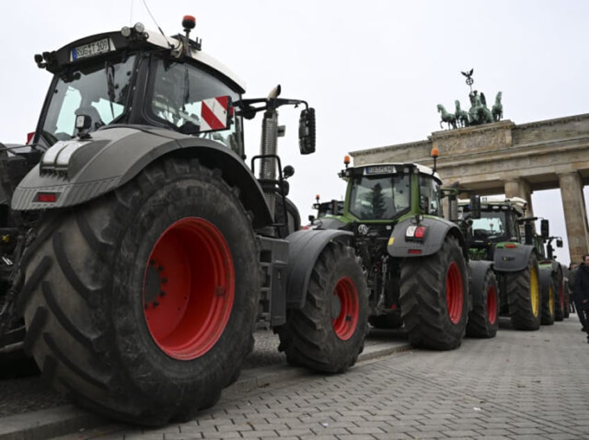 BERLIN, GERMANY - DECEMBER 18: German farmers gather with their tractors in front of the Brandenburg Gate to protest against the increase in fuel prices following the German coalition parties decision to remove the subsidies for agricultural diesel in Berlin, Germany on December 18, 2023. (Photo by Halil Sagirkaya/Anadolu via …