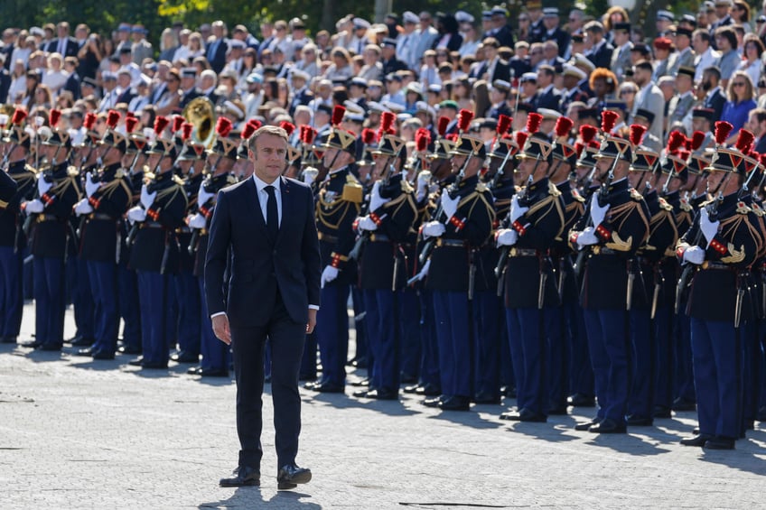 France's President Emmanuel Macron (C) reviews the troops during the Bastille Day military parade on the Avenue Foch with the Arc de Triomphe in background, in Paris on July 14, 2024. (Photo by Ludovic MARIN / AFP) (Photo by LUDOVIC MARIN/AFP via Getty Images)