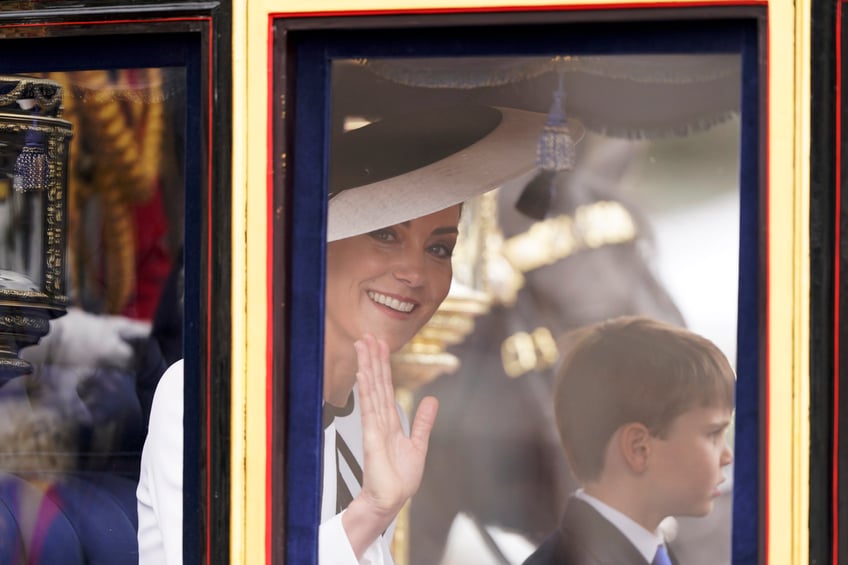 Britain's Kate, Princess of Wales, waves as she and Prince Louis travel along The Mall for the Trooping the Color ceremony at Horse Guards Parade, London, Saturday, June 15, 2024. Britain is putting on a display of birthday pageantry for King Charles III, a military parade that is the Princess of Wales' first public appearance since her cancer diagnosis early this year. (AP Photo/Alberto Pezzali)