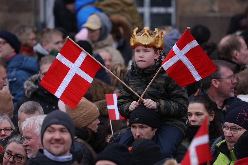 COPENHAGEN, DENMARK - JANUARY 14: A young boy wears a crown and waves flags prior to the proclamation of the Crown Prince as new Danish King Frederik X on January 14, 2024 in Copenhagen, Denmark. King Frederik X is succeeding Queen Margrethe II, who is stepping down after reigning for 51 years. (Photo by Sean Gallup/Getty Images)