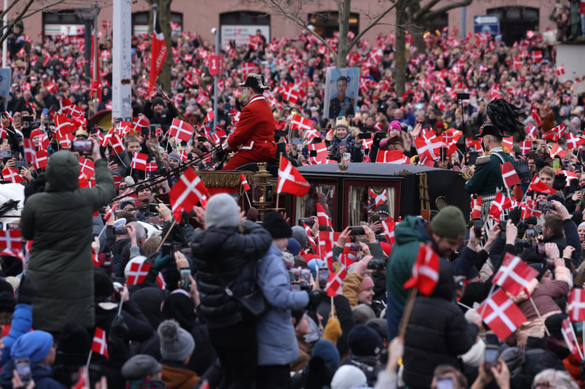 COPENHAGEN, DENMARK - JANUARY 14: The carriage of Queen Margrethe II of Denmark arrives as crowds of people wave Danish flags ahead the proclamation of Crown Prince as new Danish King Frederik X on January 14, 2024 in Copenhagen, Denmark. King Frederik X is succeeding Queen Margrethe II, who is stepping down after reigning for 51 years. (Photo by Sean Gallup/Getty Images)