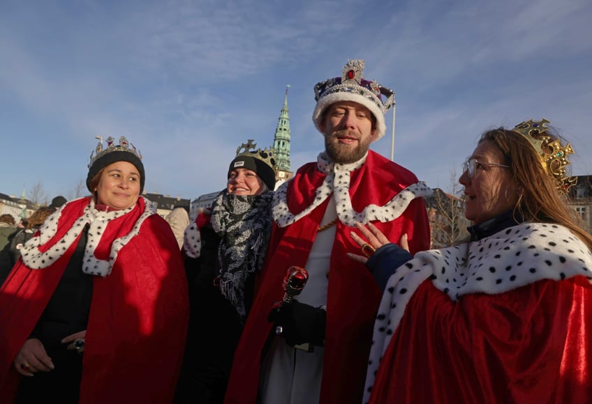 COPENHAGEN, DENMARK - JANUARY 14: Well-wishers wearing crowns and coronation robes gather outside Christiansborg Palace on January 14, 2024 in Copenhagen, Denmark. Crown Prince Frederik will succeed Queen Margrethe II, who is stepping down after reigning for 51 years, as King Frederik X later today. (Photo by Sean Gallup/Getty Images)