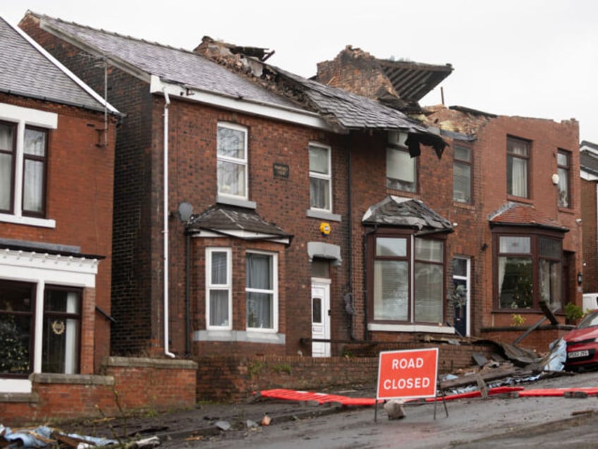 STALYBRIDGE, ENGLAND - DECEMBER 28: Roofs can be seen ripped off homes on Hough Hill Road following a tornado on December 28, 2023 in Stalybridge, England. Houses in the Tameside area of Greater Manchester have been damaged by a localised tornado during Storm Gerrit. Police declared a major incident last …