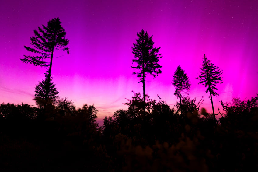 Northern lights appear in the night sky over the Pferdskopf near Treisberg in the Hochtaunus district of Hesse, Germany, early Saturday, May 11, 2024. (Lando Hass/dpa via AP)