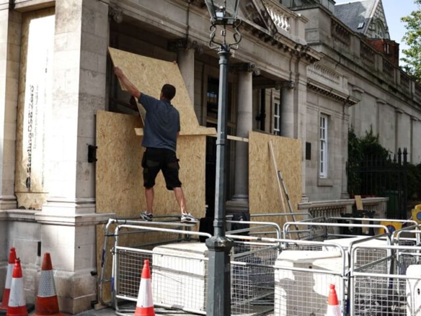 pictures workers board up windows ahead of free palestine protest at israeli embassy london