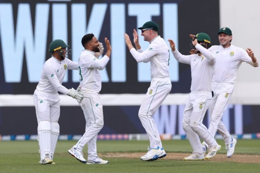 Dane Piedt (second left) and the South Africa players celebrate the wicket of Kane William