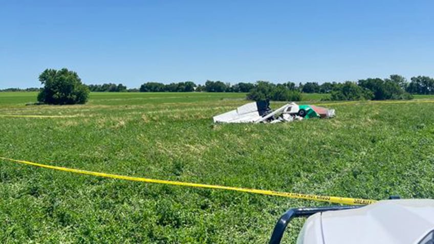 small airplane wreckage in field
