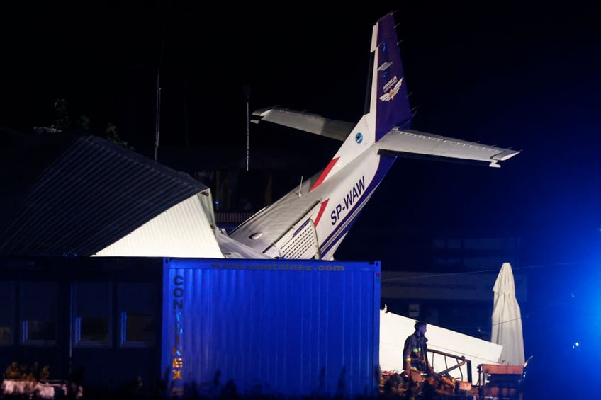 pilot and four on ground killed by aircraft crashing into hangar during storm in poland