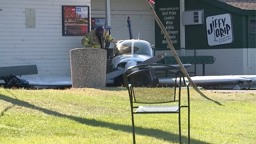 Firefighter next to crashed plane