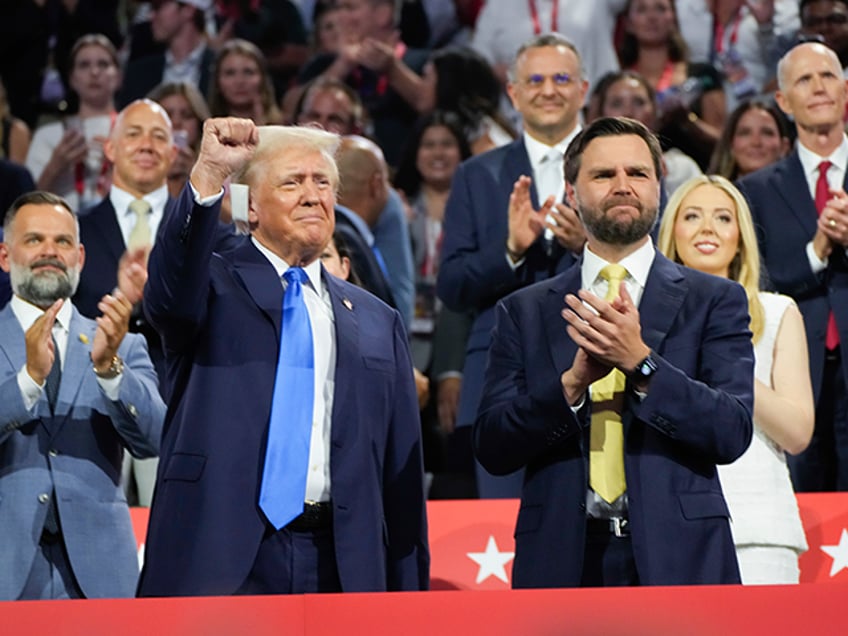 Republican presidential candidate former President Donald Trump is introduced during the Republican National Convention Tuesday, July 16, 2024, in Milwaukee. At right is Republican vice presidential candidate JD Vance. (AP Photo/Paul Sancya)