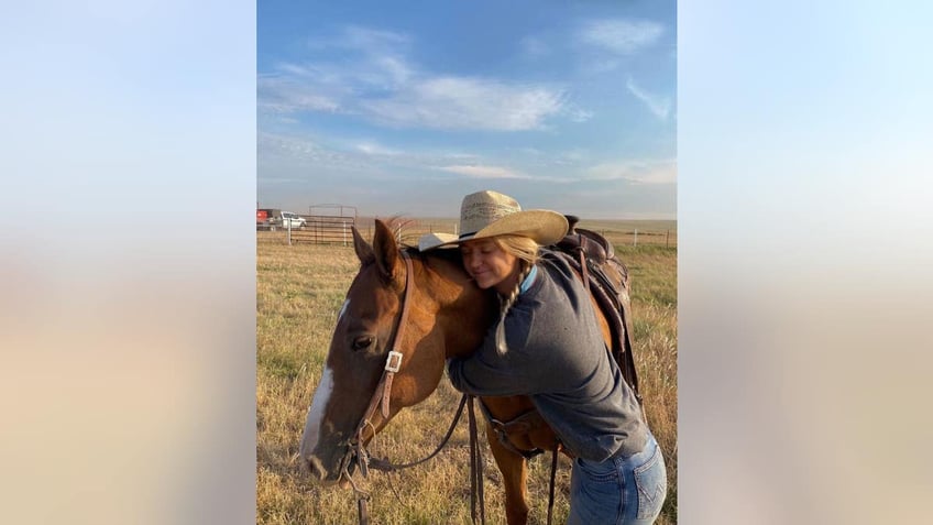 paige drummond hugging her horse 