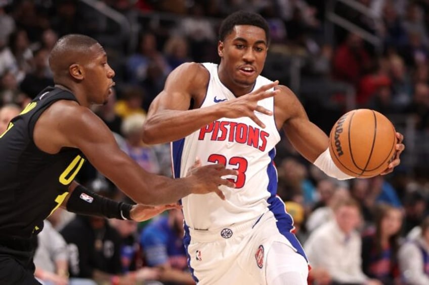 Detroit's Jaden Ivey tries to drive around Kris Dunn of the Utah Jazz in the Pistons' 119-111 NBA loss to the Jazz