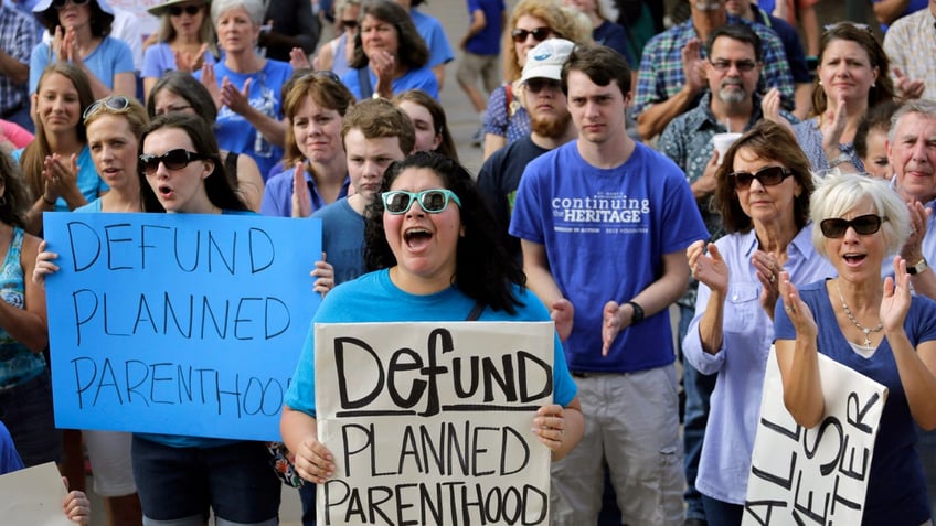 abortion protesters holding signs