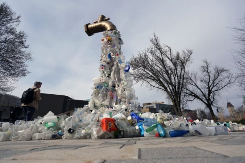 A sculpture titled "Giant Plastic Tap" by Canadian artist Benjamin Von Wong is displayed o