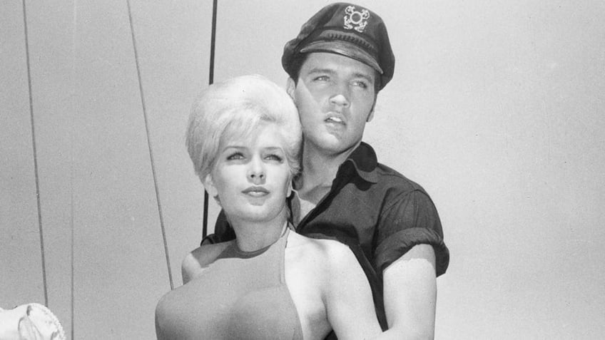 Stella Stevens being held from behind by Elvis Presley