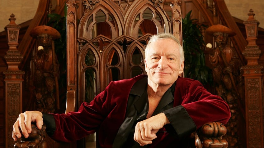 Hugh Hefner in a red robe at his mansion