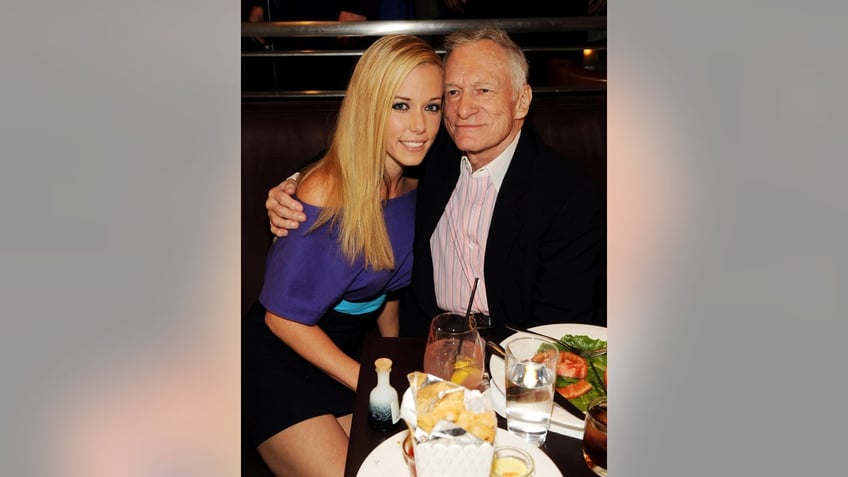 Hugh Hefner embracing Kendra Wilkinson
