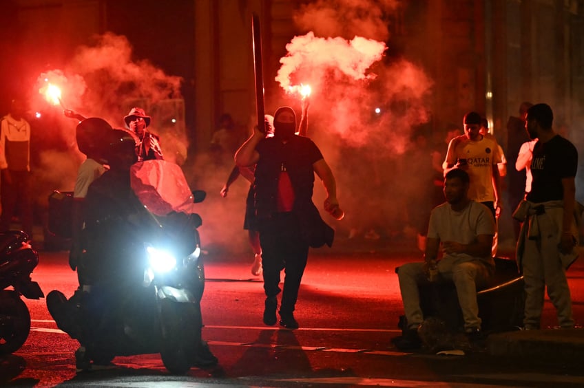 Paris Saint-Germain (PSG) supporters gather holding flares on a street in Paris early June 1, 2025, during celebrations following their 5-0 victory in the UEFA Champions League final football match between Paris Saint-Germain (PSG) and Inter Milan held in Munich. (Photo by LOU BENOIST / AFP) (Photo by LOU BENOIST/AFP via Getty Images)