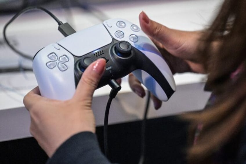 A member of the media tries out Sony's PlayStation 5 console during the Tokyo Game Show in