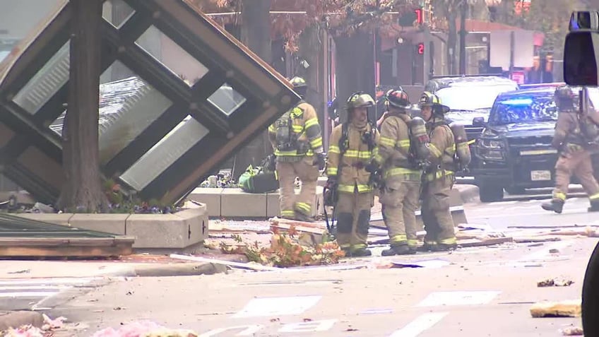 Police officers investigating the debris