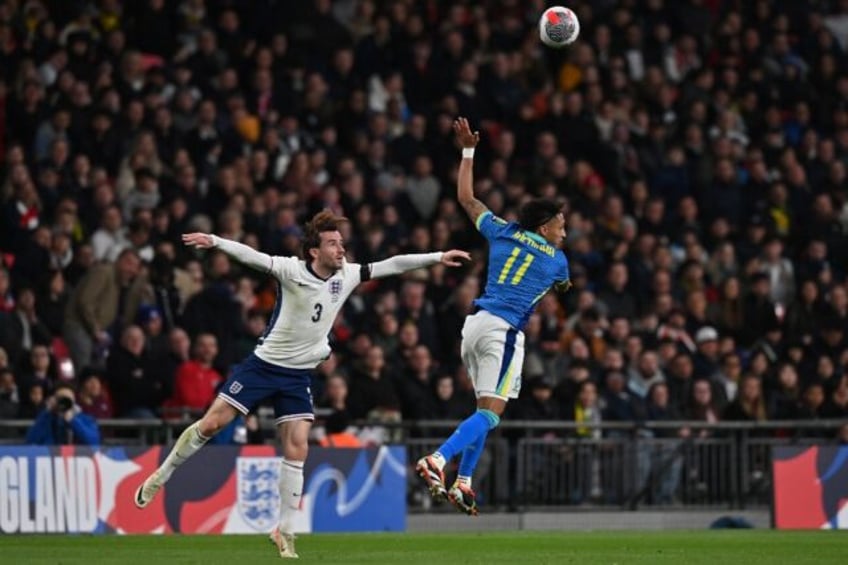 England defender Ben Chilwell (L) in action against Brazil midfielder Raphinha (R) during