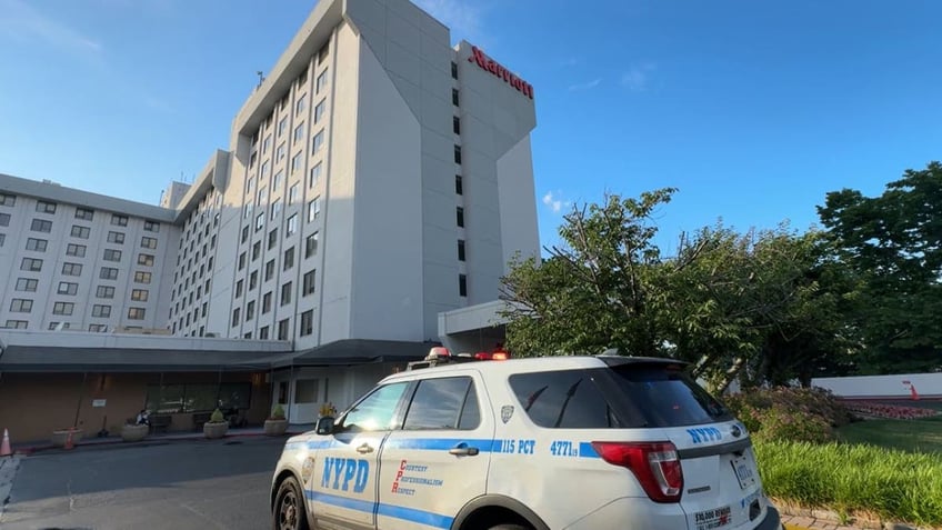 A police vehicle outside an airport hotel in Queens New York City after a man was robbed of $250,000.