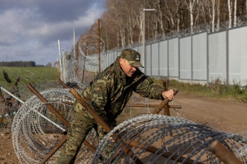 The five-metre-high (16-foot) metal barrier along the border built in 2022 has been reinfo