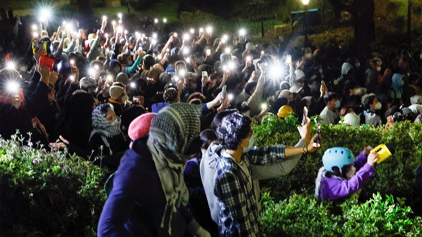 Anti-Israel protesters shine lights down on police at UCLA