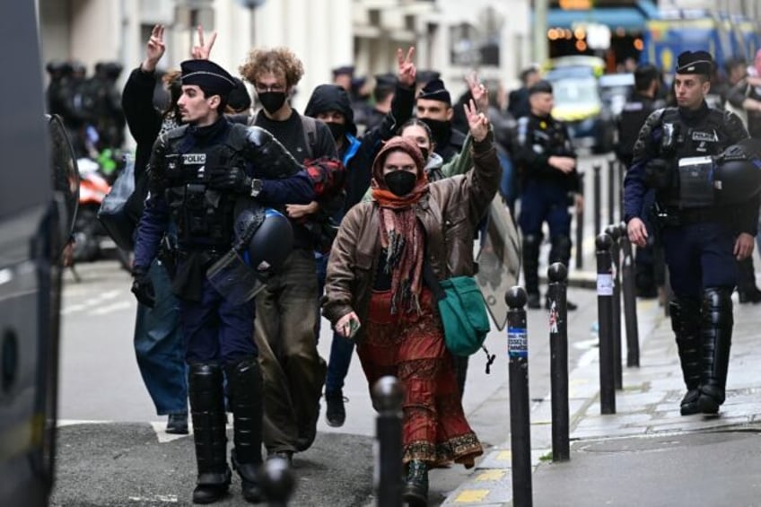 Student demonstrators were escorted out of the Sciences Po building by police