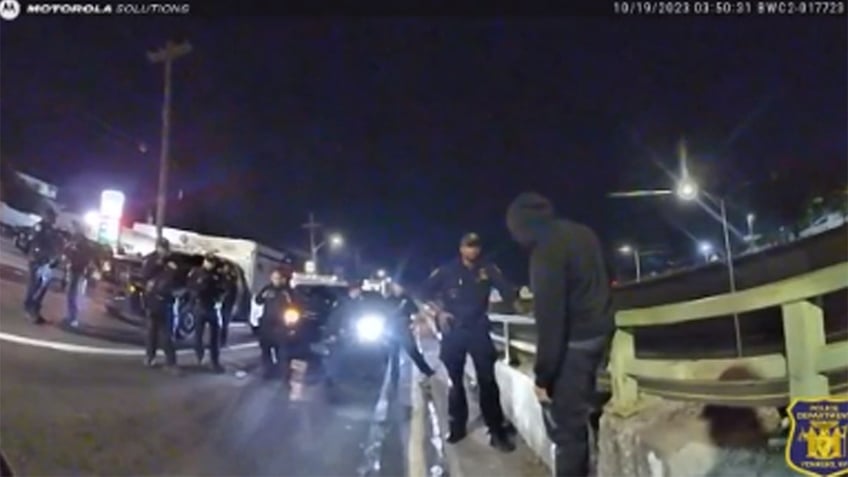 police dash to save man dangling from overpass in dramatic bodycam footage