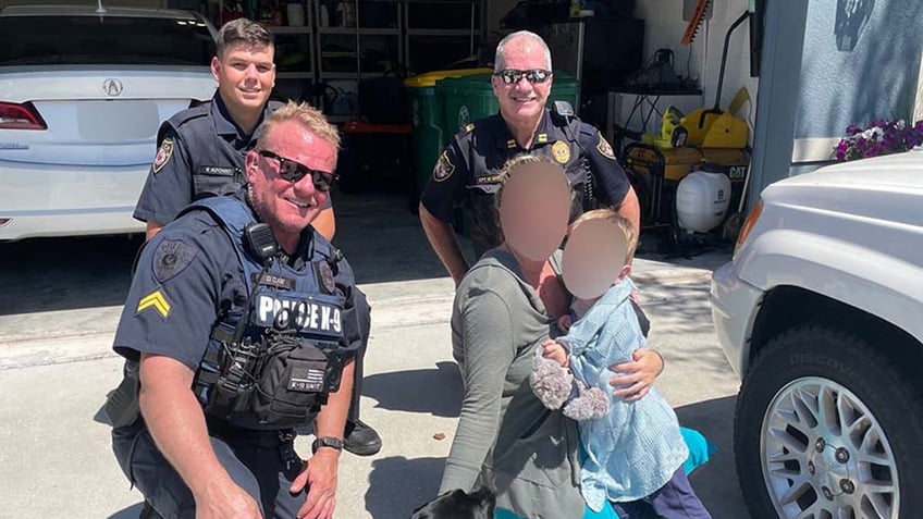 K-9 Midnight and Clark pose with the boy and his mom