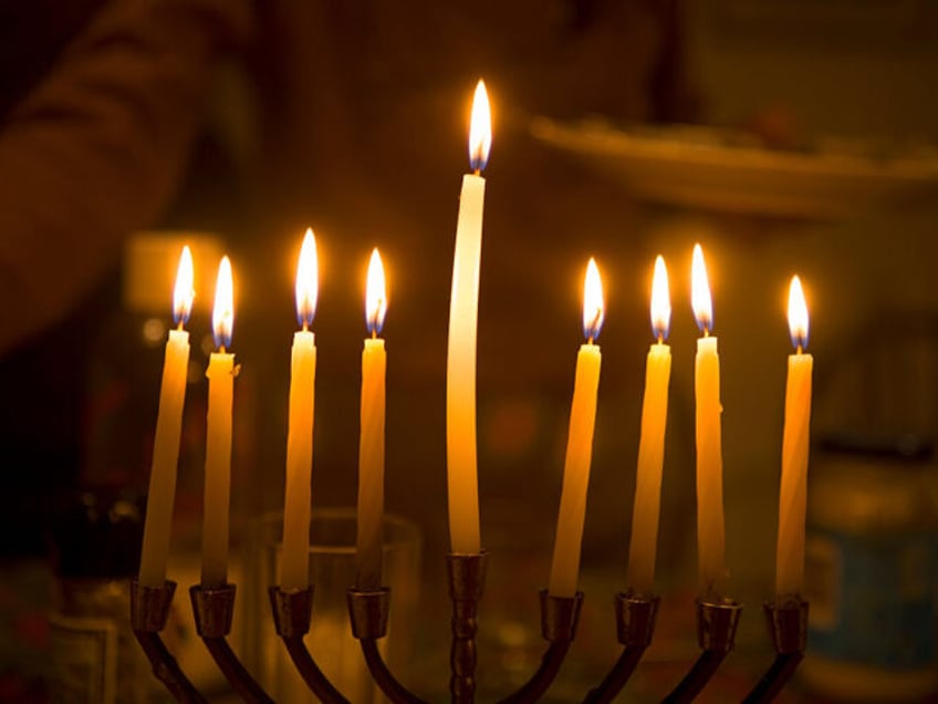 A Menorah at a family celebration on the last night of the Hannukah Jewish fesitval. The menorah is a seven branched candelabrala and is one of the oldest symbols of the Jewish people. It is traditionally lit progressively over the eight nights of the Hannukah Festival, also known as the …