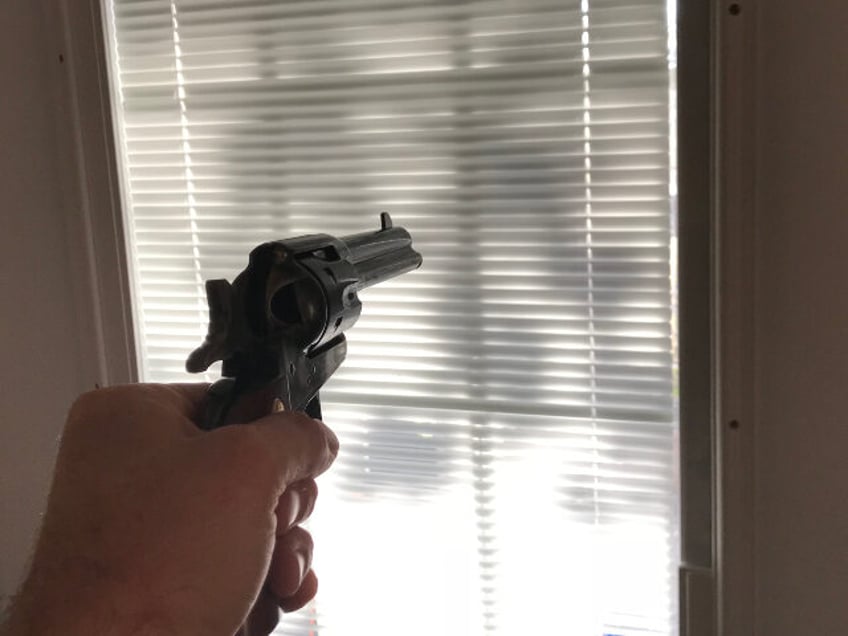 Gun pointed at window or door