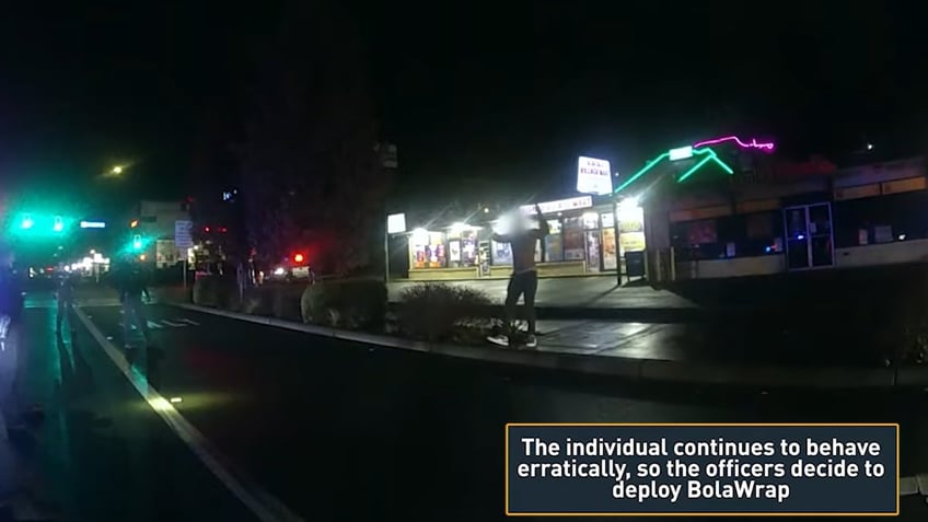 An erratic suspect saying he "doesn't have control of his body" is face-to-face with a squad of officers who bring him down from a distance.