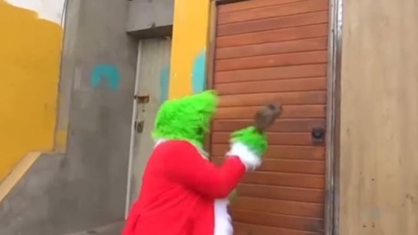 The "Grinch" busting down a door