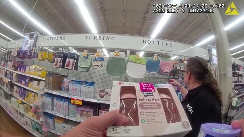 Officer bodycam footage shows Cpl Willoughby holding two infant milk bottles