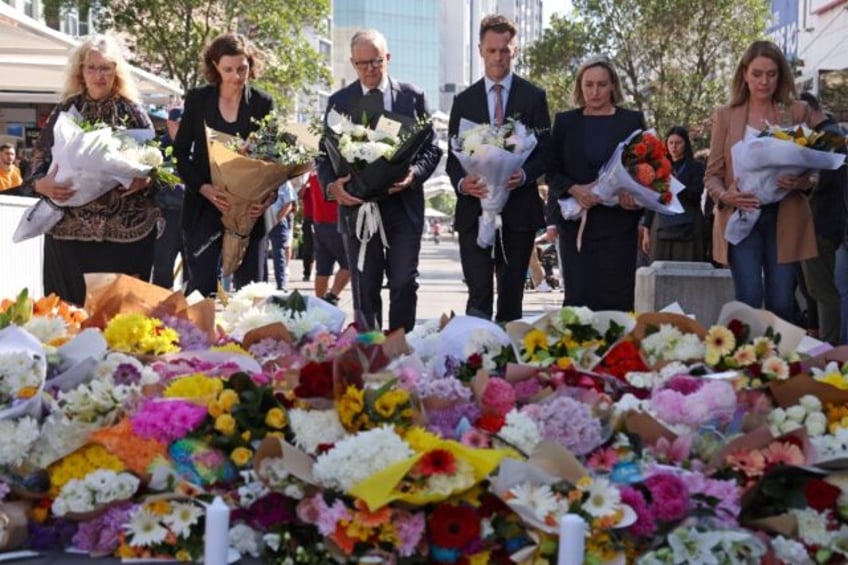 Australian Prime Minister Anthony Albanese (C, with NSW premier Chris Minns) leave flowers