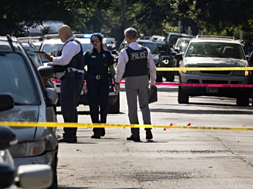 CHICAGO, ILLINOIS - JULY 06: Police investigate the scene of a drive-by shooting on July 0