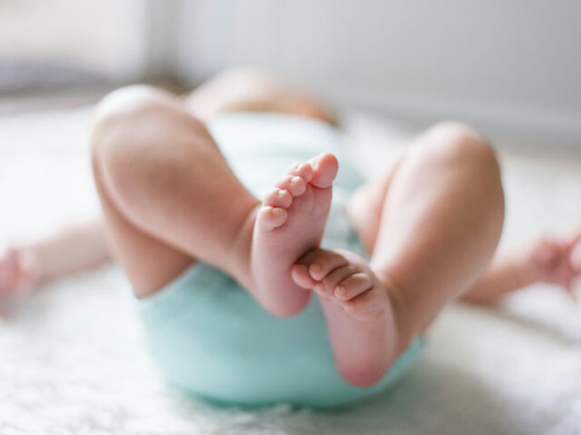 baby-laying-on-bed