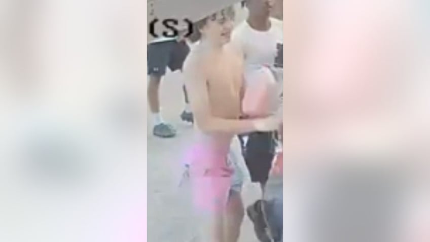shirtless suspect wearing pink shorts